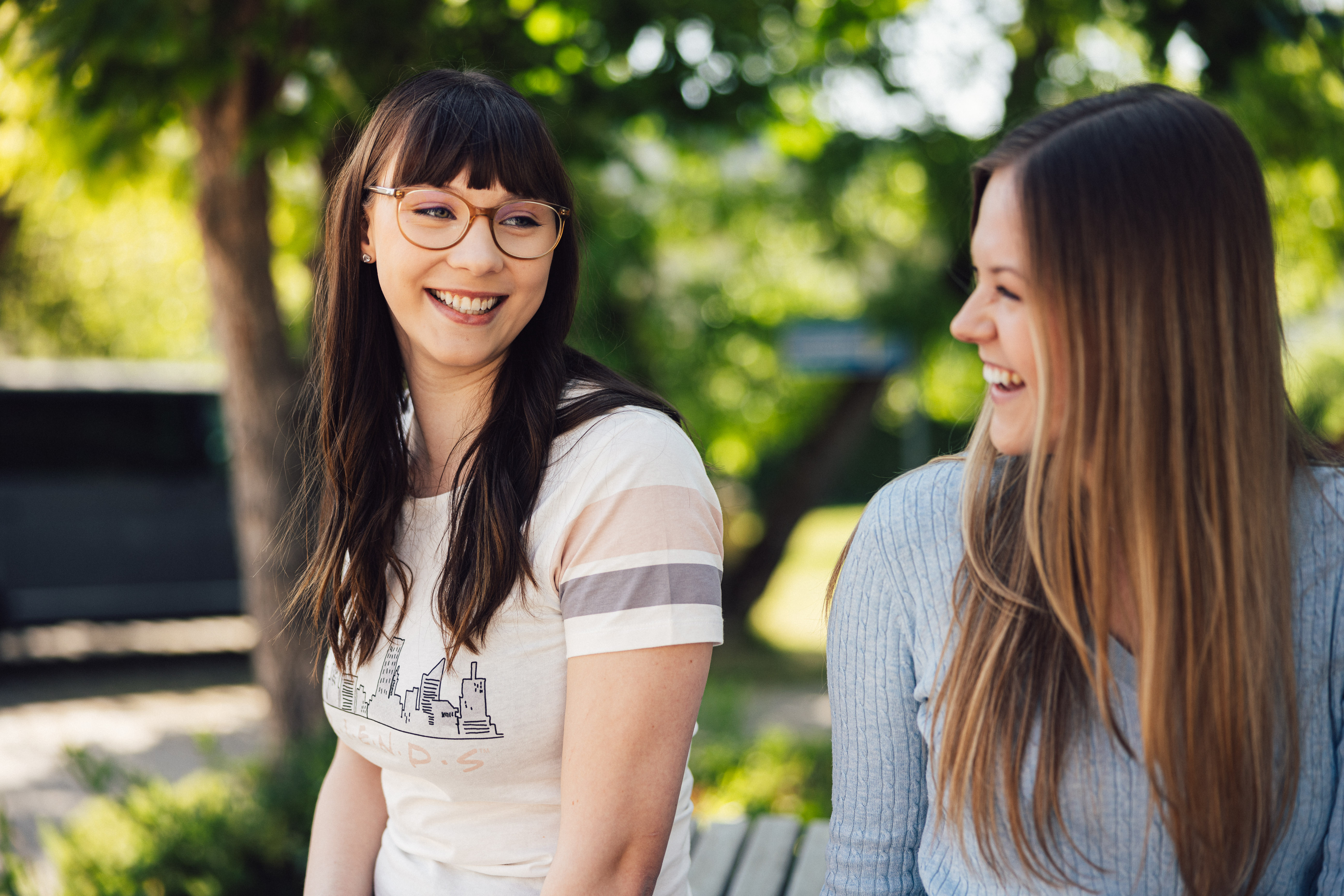 Young ladies chatting in the garden and having fun