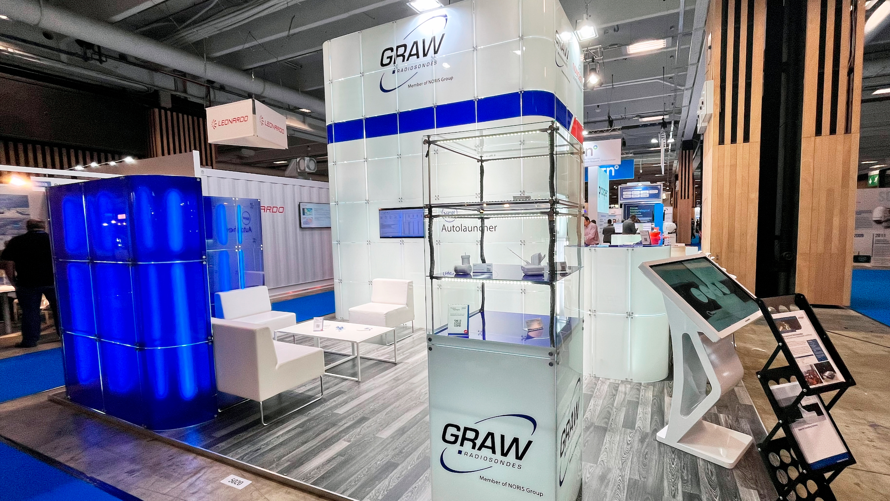 The image shows the booth of Graw Radiosondes at MTW Expo. A whitre clean glas booth.