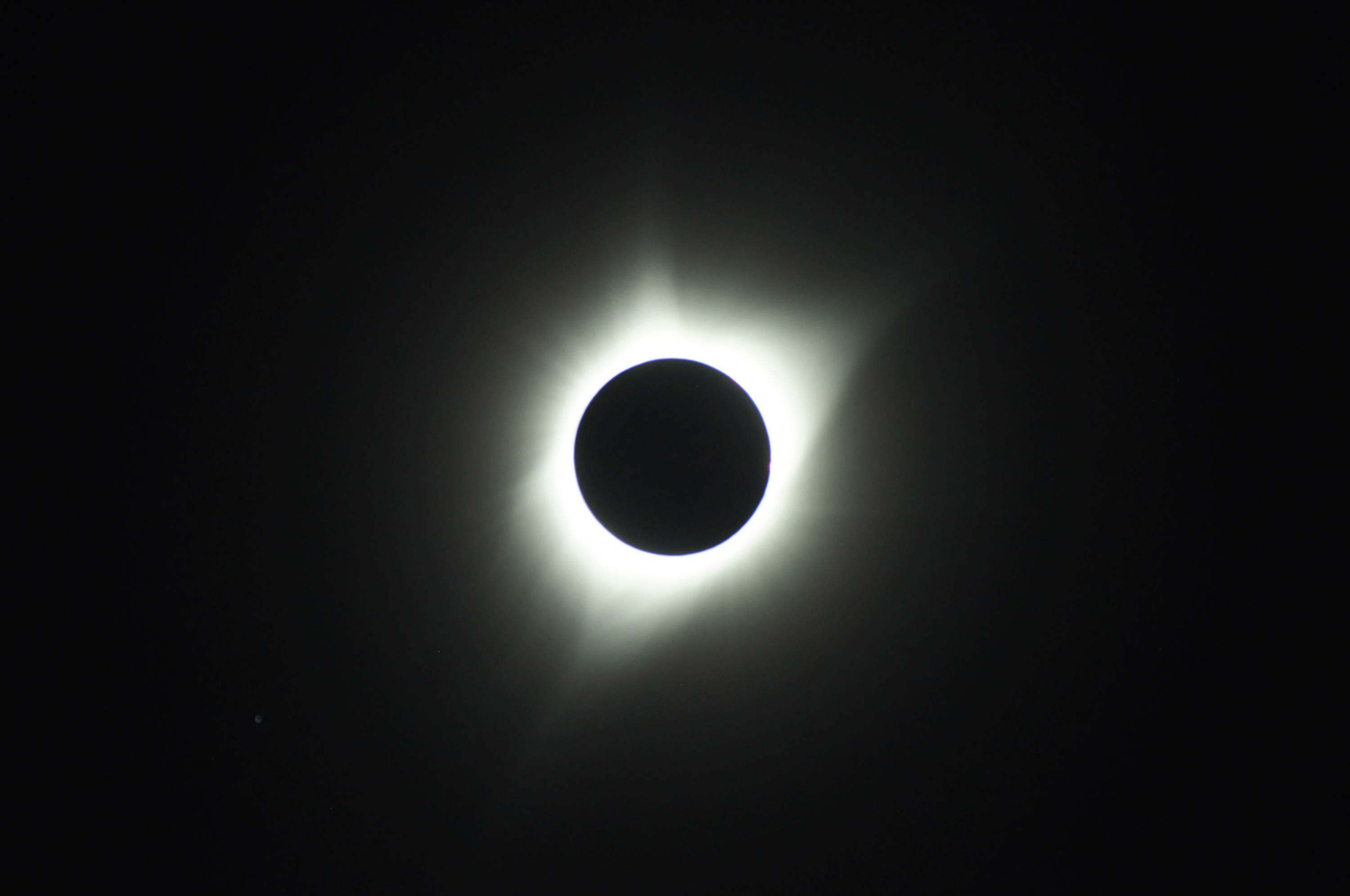 The image shows a photo of the solar eclipse, with the darkened sun and its corona.